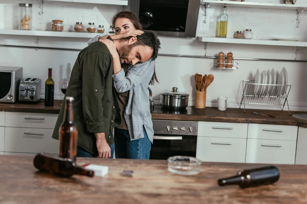 Trauma Bonding couple hugging after drinking alcohol