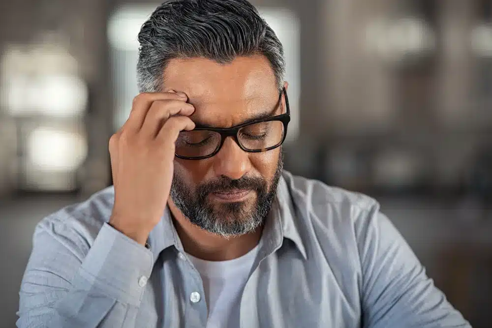Stressed man with his hand on his head