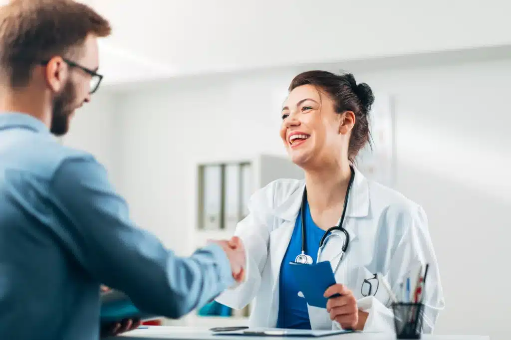 Doctor greeting a male client coming into treatment.